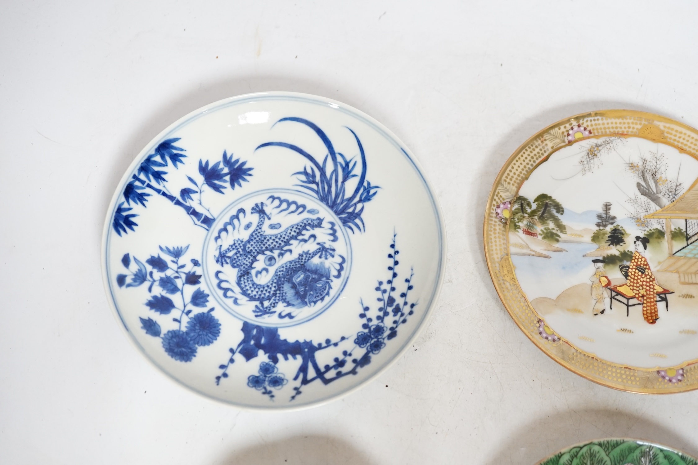 Four Chinese or Japanese porcelain saucers, largest 16.5 cm diameter